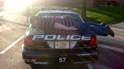 Teen planking on Cop car.