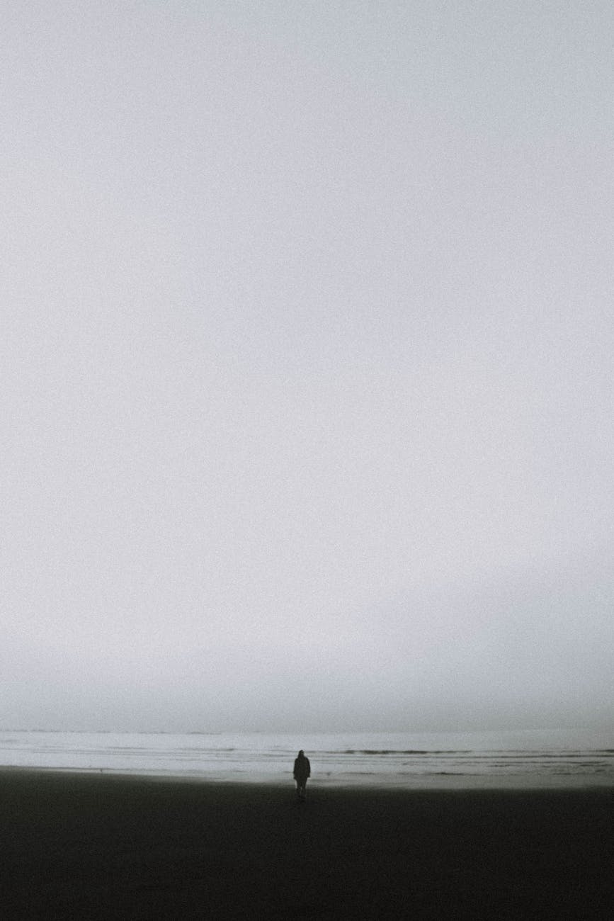 lonely person standing on seashore