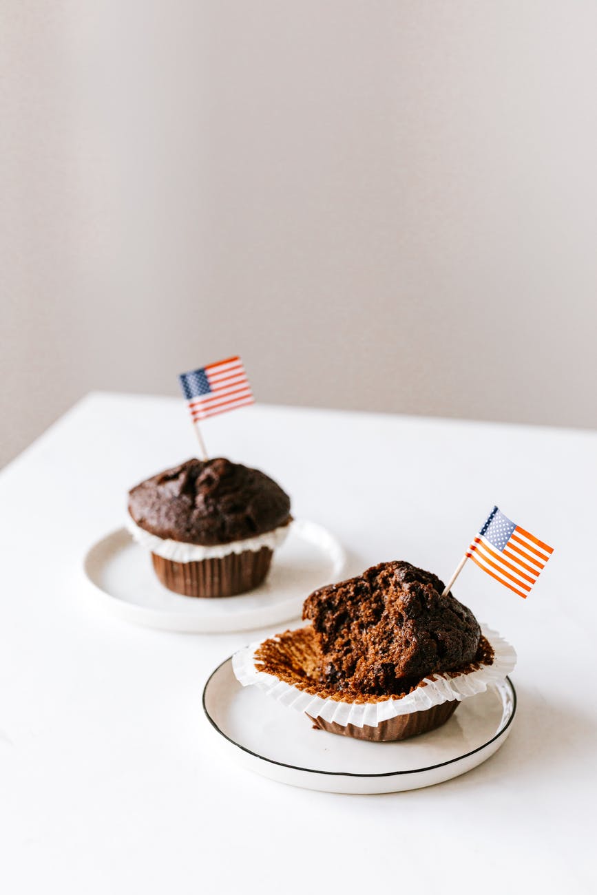 tasty festive muffins decorated with cocktail flags of united states